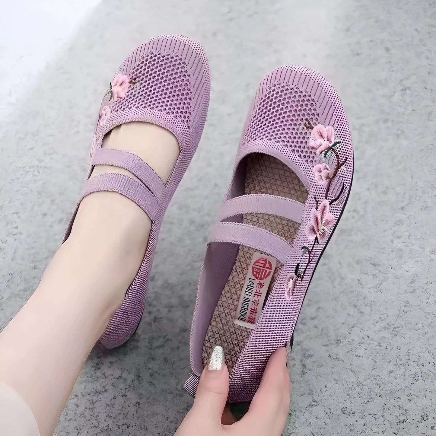 A pair of slip-on flat shoes with an elastic upper and rubber sole, shown in an embroidered colour option.