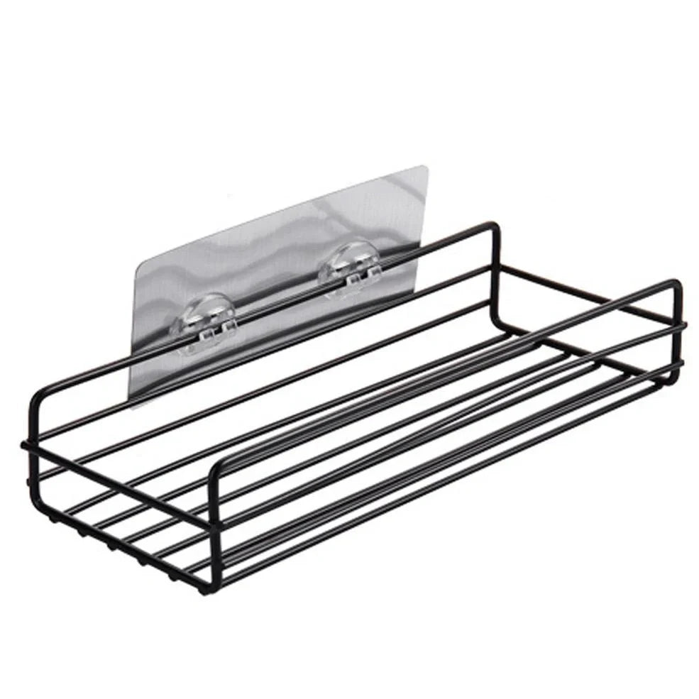 Black wrought iron bathroom shelf, 60cm long with drainage holes, holding shampoo bottles over tub edge