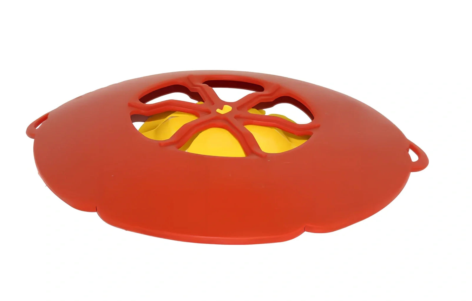 Green silicone spill stopper pan lid on cooking pot showing flexible edges and steam vent