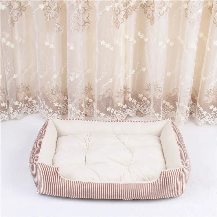 Oval cloth pet bed for dogs or cats in a striped colour pattern, showing its soft cushion shape.