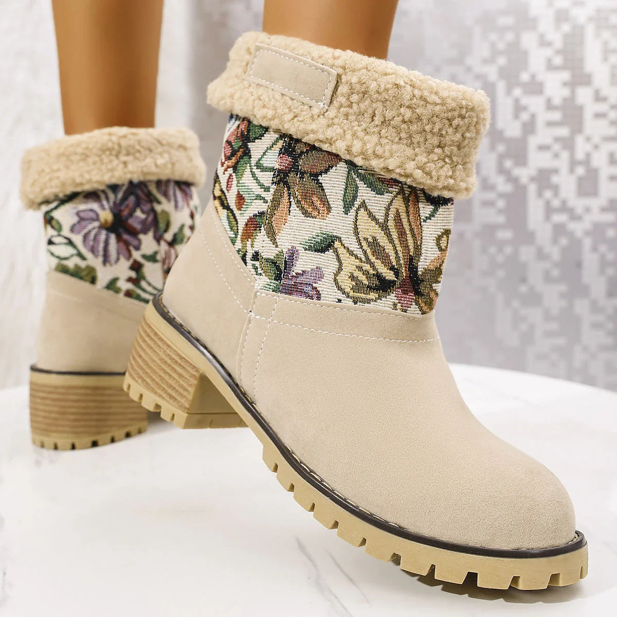 Floral embroidered snow boots in off-white, black, and pink colors with thick square heels and round toe shape