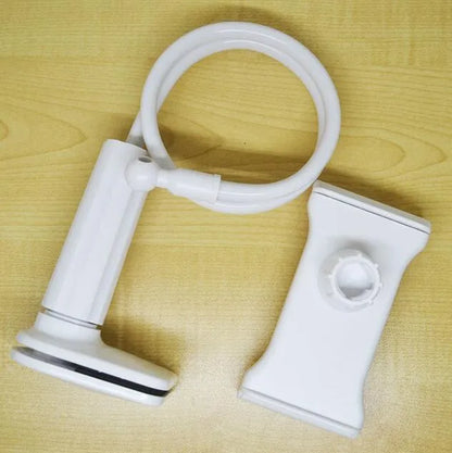 Bedside oversize flat panel handset with long arm holding a mobile phone on a table