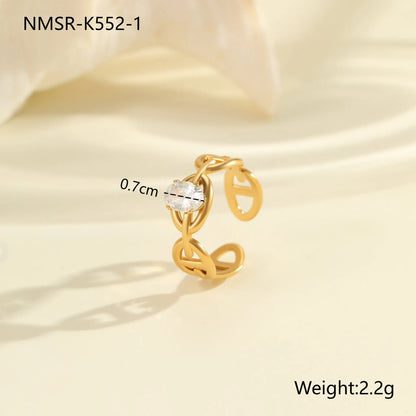 Geometric zircon ring showing round, oval and quadrangular design elements in stainless steel with electroplated finish