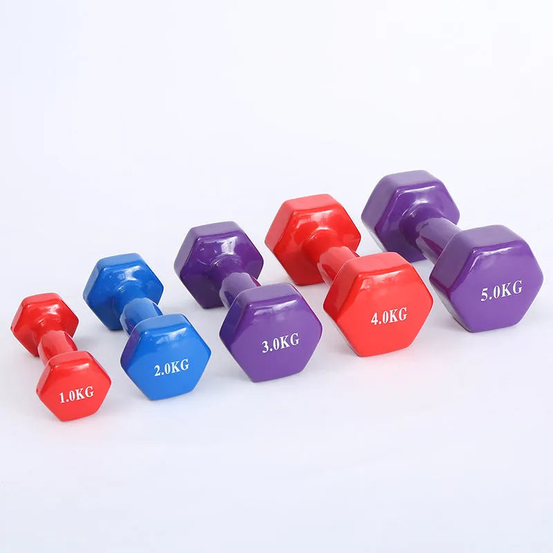 A pair of brightly coloured plastic fitness dumbbells with a glossy surface, shown on a home floor.