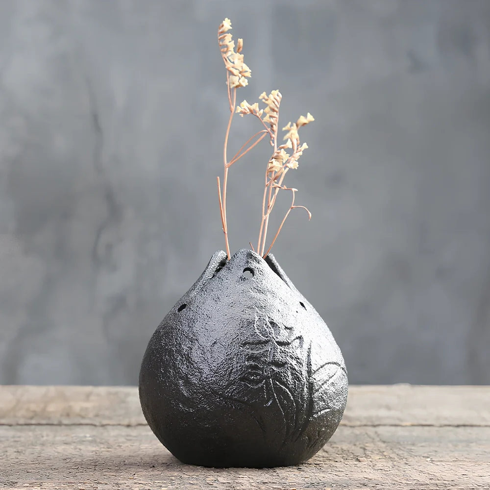 Handmade stoneware Zen Chinese flower arrangement vase with floating lotus device on wooden table