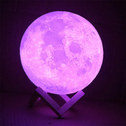 3D printed white moon lamp on wooden stand with textured lunar surface, glowing with warm yellow LED light.