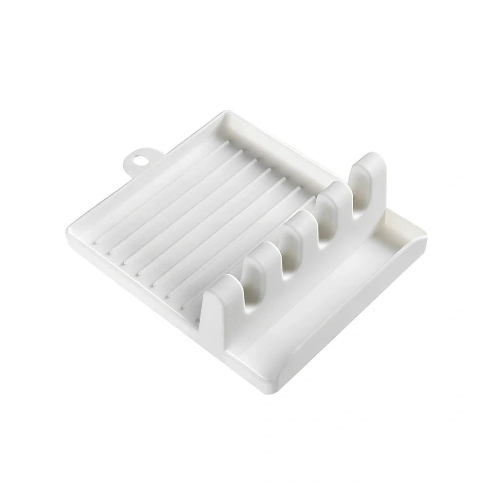 Green silicone spatula holder with four slots for kitchen utensils on countertop