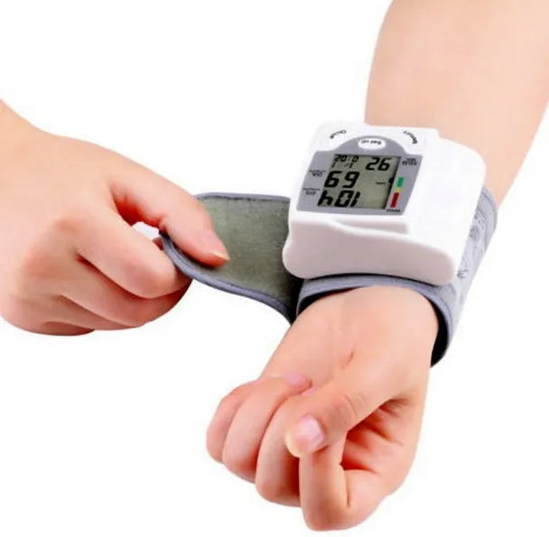 Grey wrist blood pressure monitor with compact design and digital display