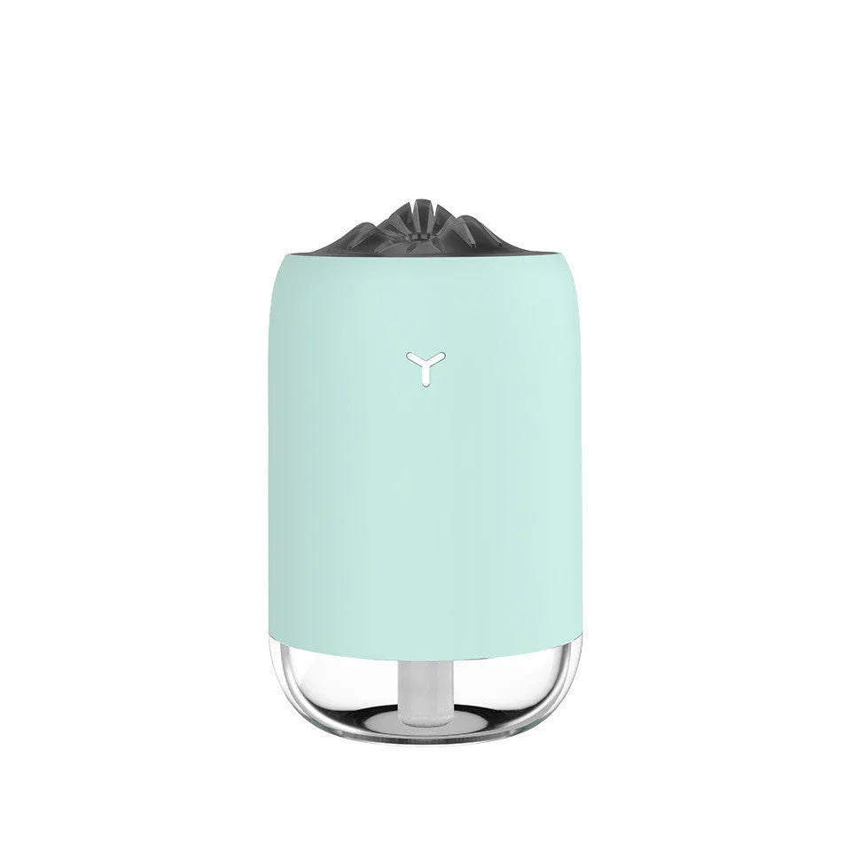 Compact cylindrical USB humidifier with night light in white, pink, or green, showing mist output.