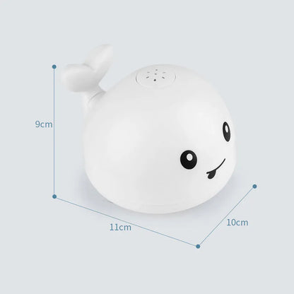 Automatic water-spraying whale bath toy with colourful lights floating in bath water.