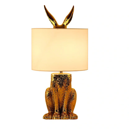 White rabbit table lamp with metal base and resin details, 24cm wide by 49cm high