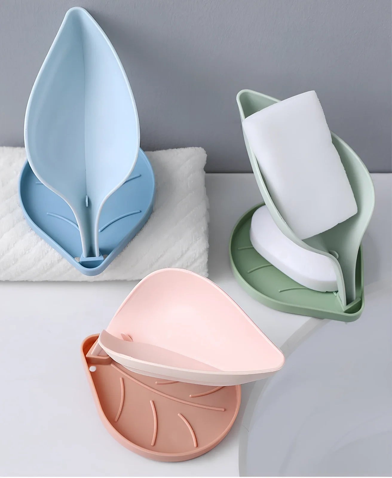 Blue bathroom soap dish with tree texture pattern and drainage channels on white ceramic sink