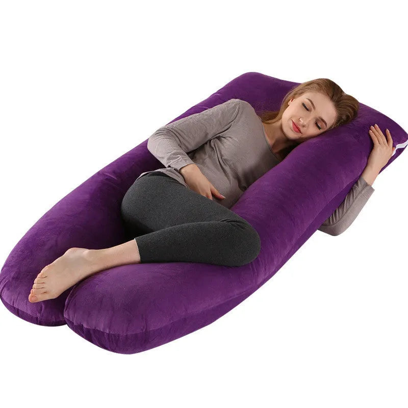 Large U-shaped pregnancy support pillow with removable cover and abdominal support belt.