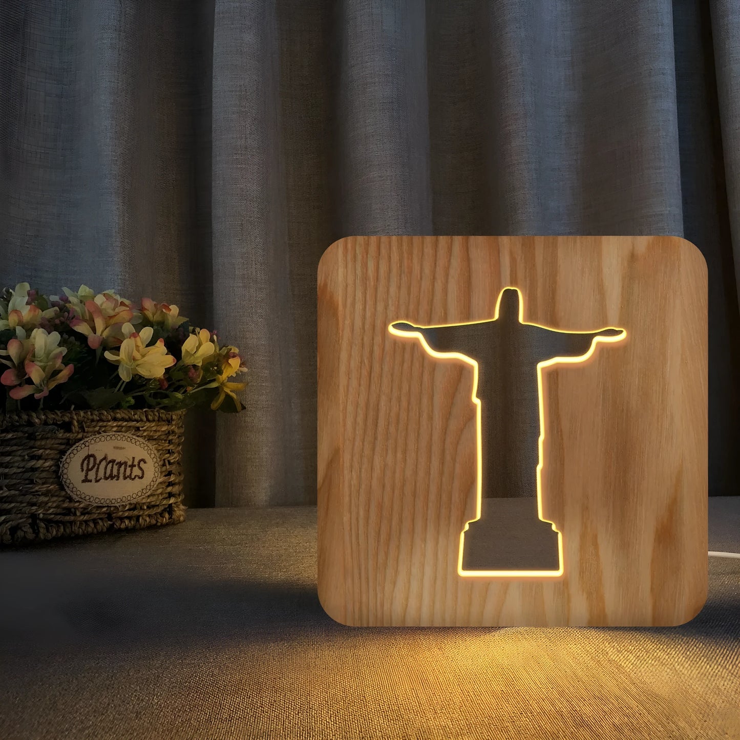 Solid wood hollow night lamp with warm white LED light on a surface