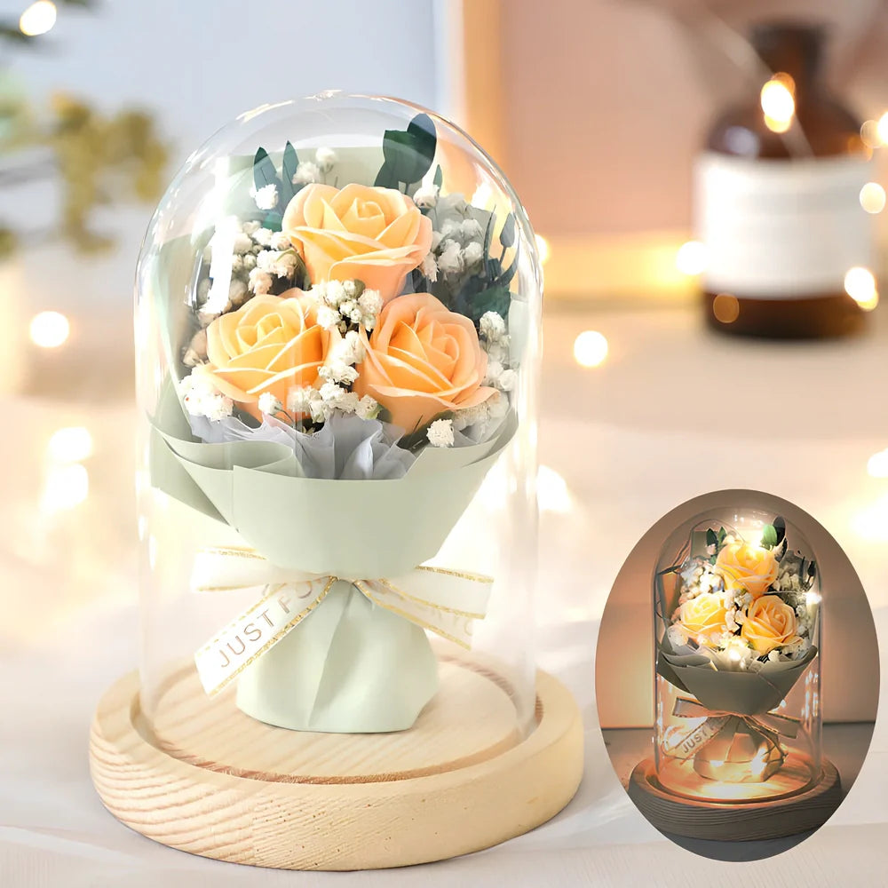 Soap flower bouquet in glass display cover with red roses visible through clear 11.2cm dome