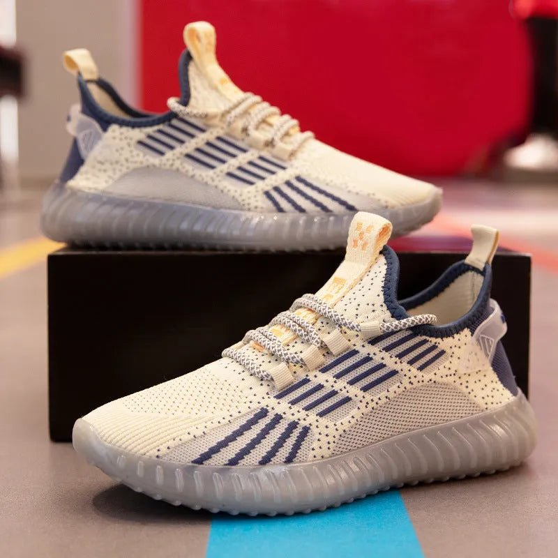 Men's low-top white mesh sneakers with a round toe and flat platform sole on a plain background.