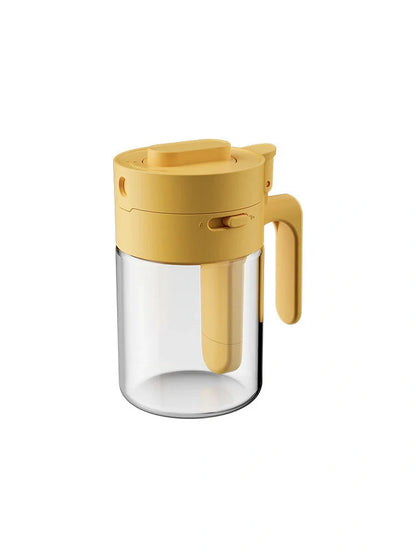 Small glass seasoning jars with lids and spoons in various colors for kitchen organization