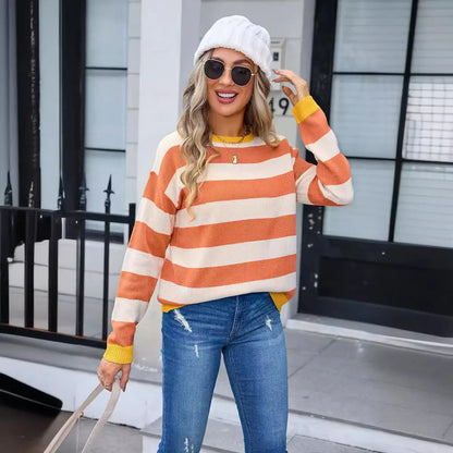 Women's loose fit striped long sleeve round neck sweater on a hanger.
