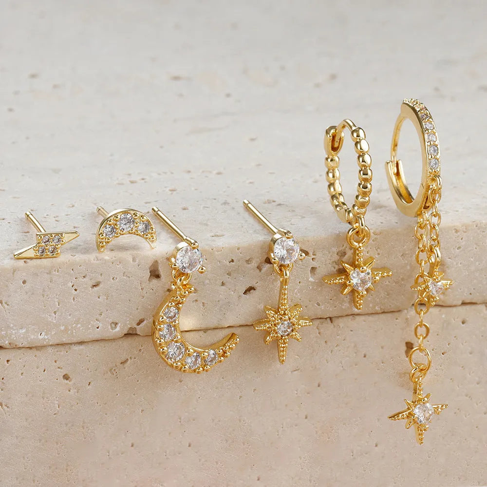 XINGX gold chain tassel earrings set showing six zircon stud earrings with dangling chain elements