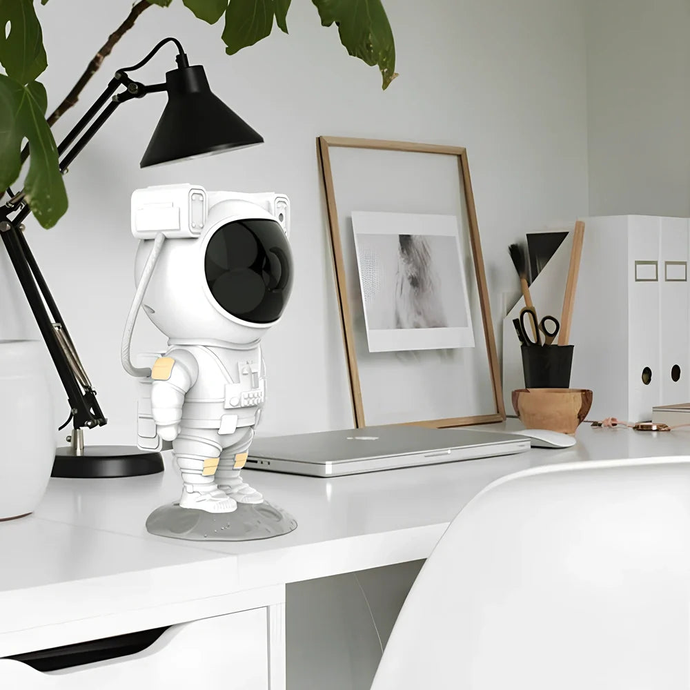 Astronaut-themed galaxy projector with adjustable nebula effects on table showing starry sky projection