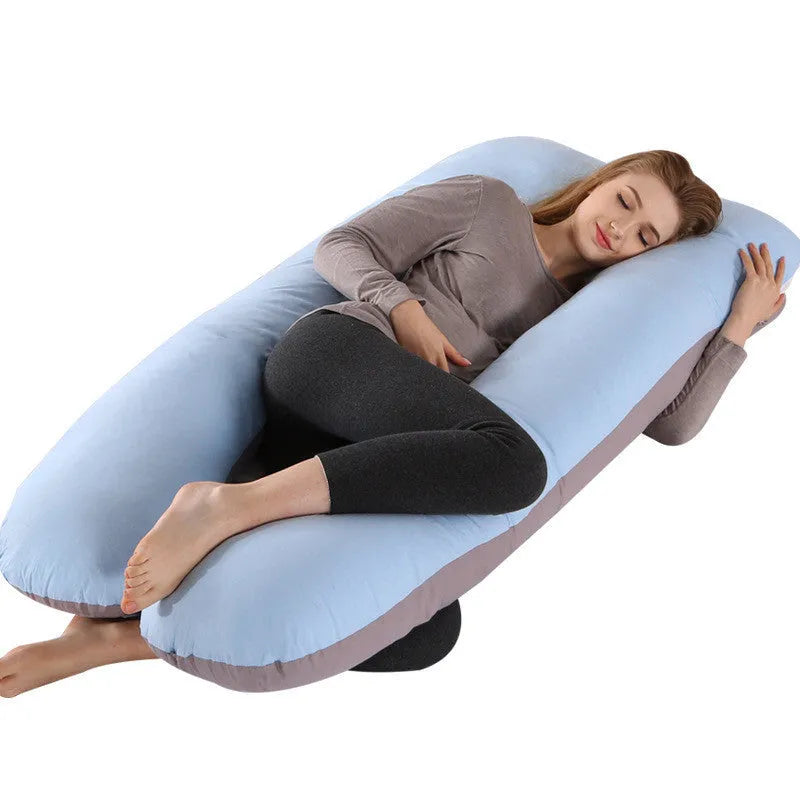 Large U-shaped pregnancy support pillow with removable cover and abdominal support belt.