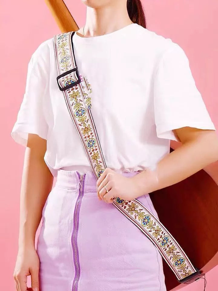 Adjustable embroidered guitar strap with durable webbing and intricate design