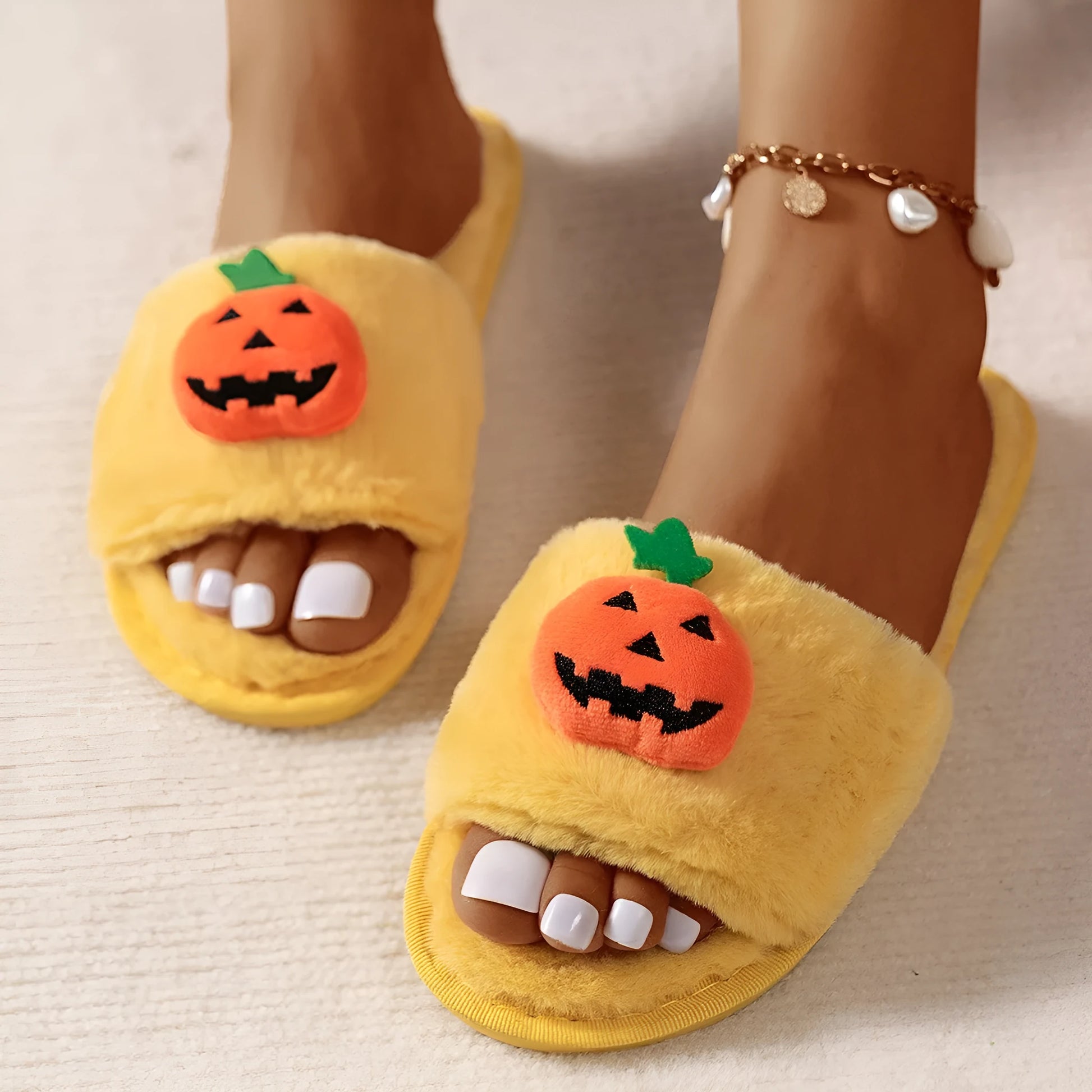 Yellow Halloween pumpkin plush open-toe slippers with synthetic fur and a light grey PVC anti-slip sole.