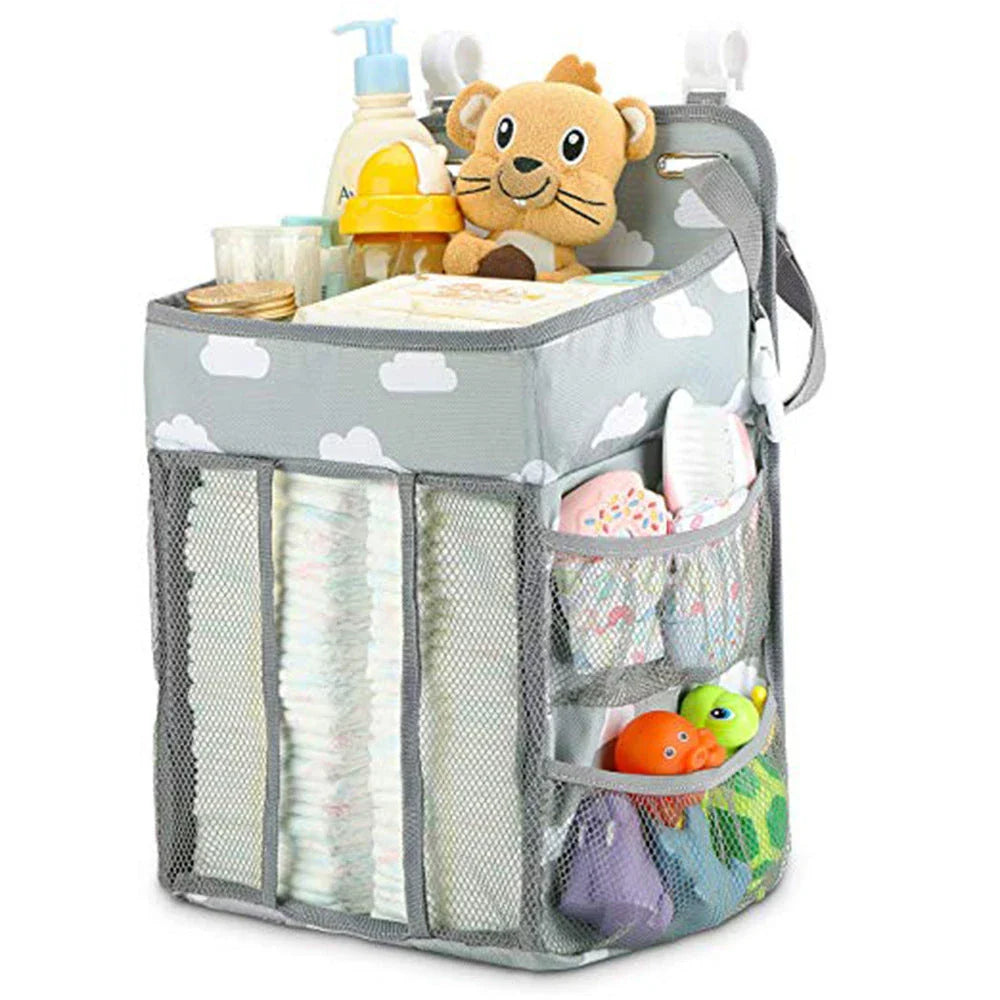 Portable baby crib organizer with hanging storage pockets for diapers, bottles, toys, and other nursery essentials