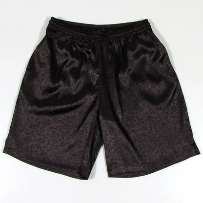 Men's black Tai Chi shorts with a white drawstring elastic waistband laid flat.