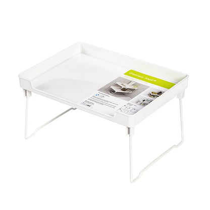 Transparent and white plastic kitchen supplies rack with multiple compartments for drawer and shelf organisation