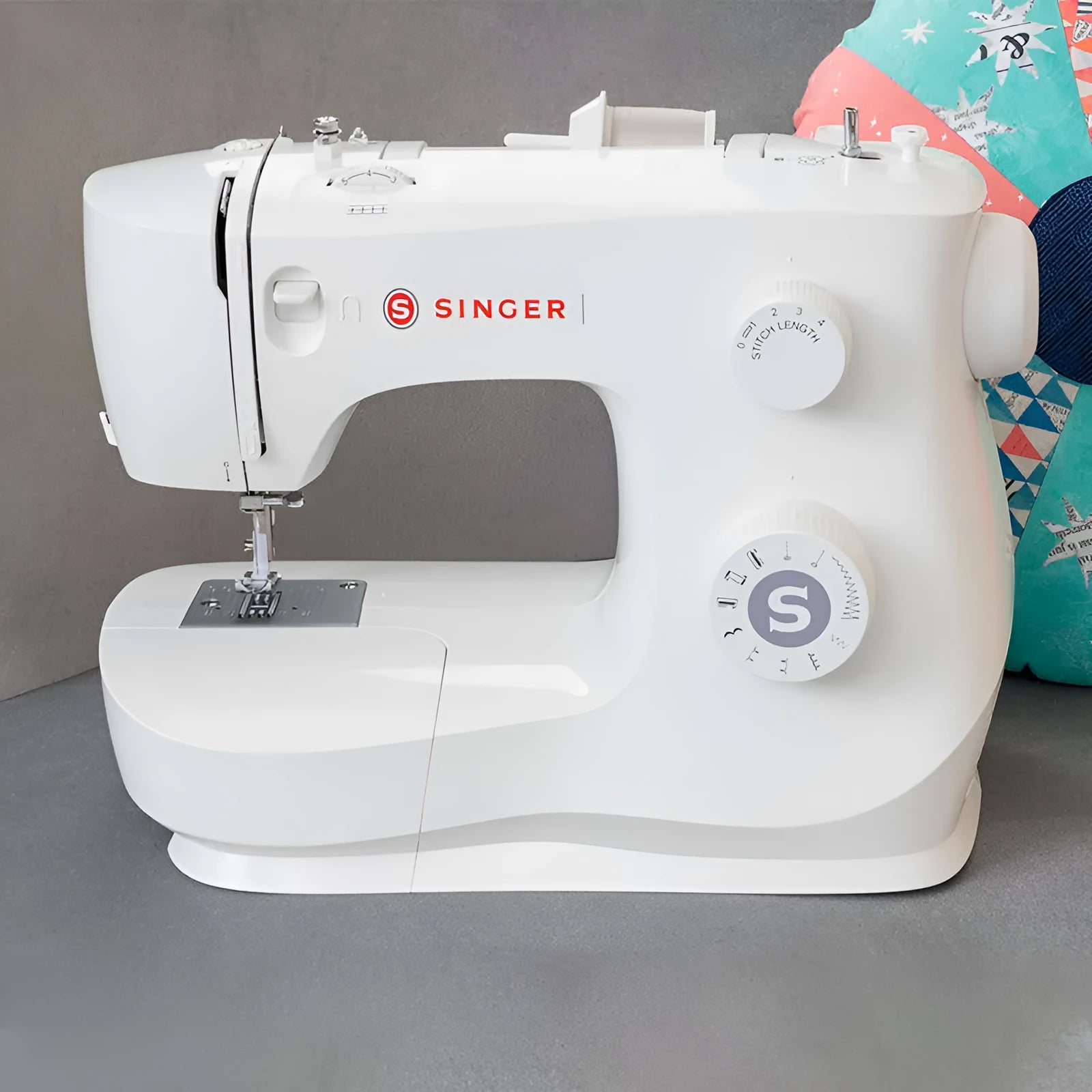M2405 portable household sewing machine with accessories on table showing compact 47x39x26cm size