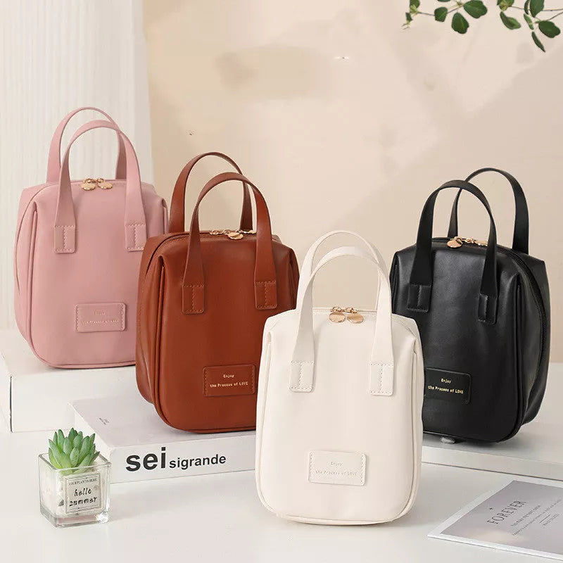 Shell-shaped cosmetic bag in cream white, mocha brown, pink, and elegant black