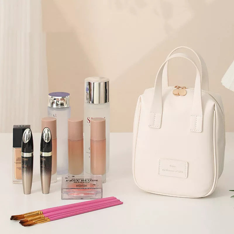 Shell-shaped cosmetic bag in cream white, mocha brown, pink, and elegant black