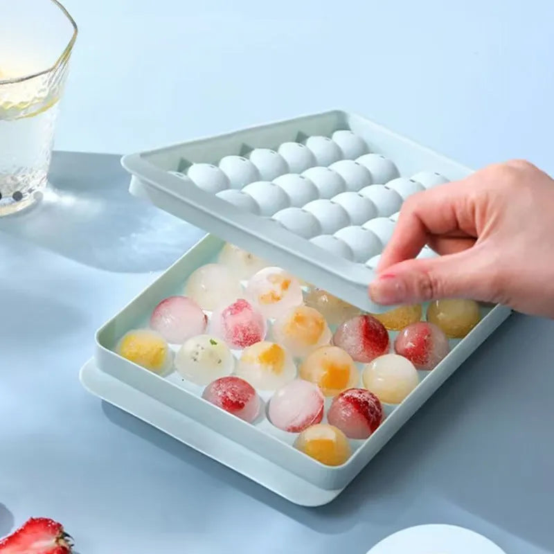 Blue silicone ice cube tray with lid showing 33 round cavities, measuring 24x14cm