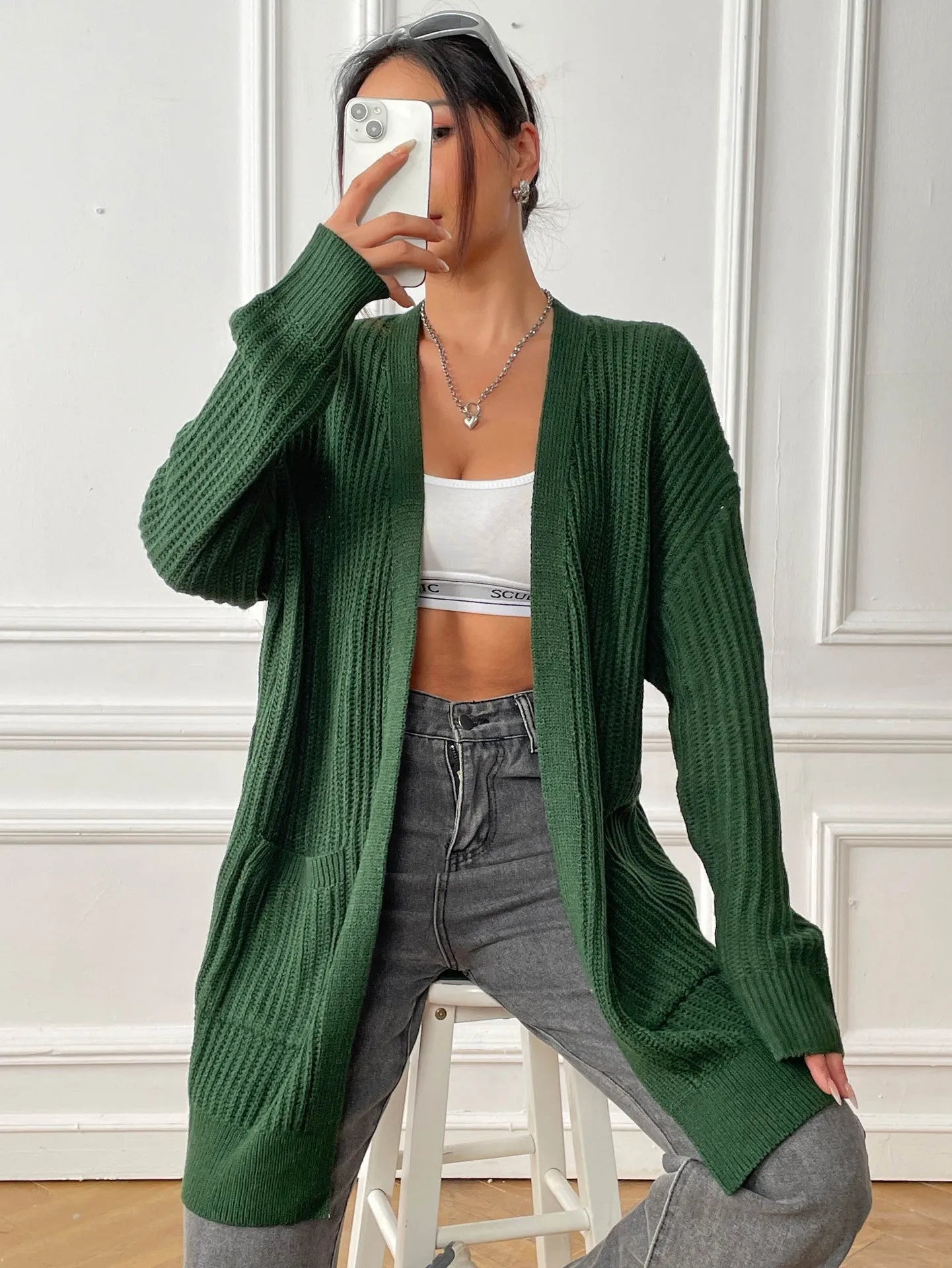 Women's dark green cardigan with two front pockets, 65cm length, loose fit design with long sleeves