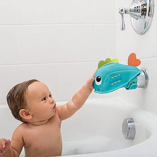Soft, water-resistant cloth bath faucet cover in a whale design to protect baby's head during bath time