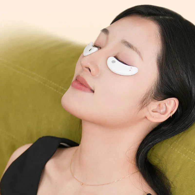 BIO9 eye massager with red light and EMS pulse modes, shown with included gel eye masks