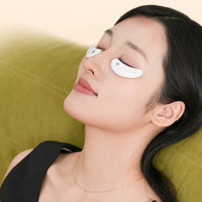 BIO9 eye massager with red light and EMS pulse modes, shown with included gel eye masks