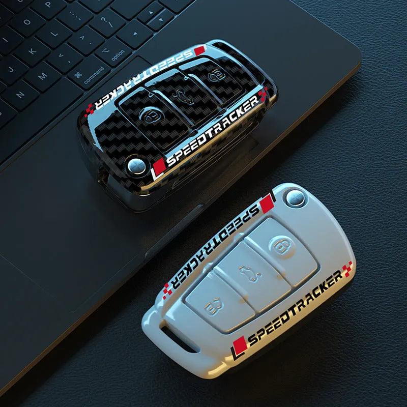 Carbon fibre style car key cover with a mirrored surface element, shown in black and white.
