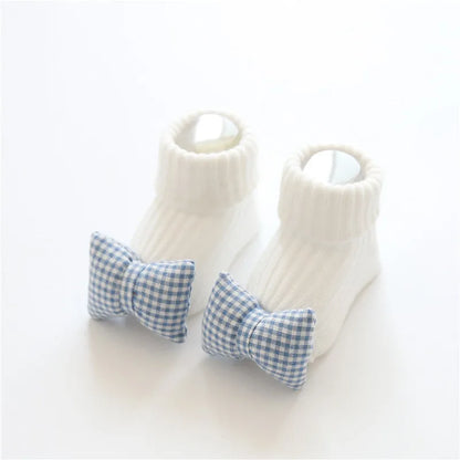 Cotton baby floor socks in assorted colours and patterns including bows, stars, and animal designs.