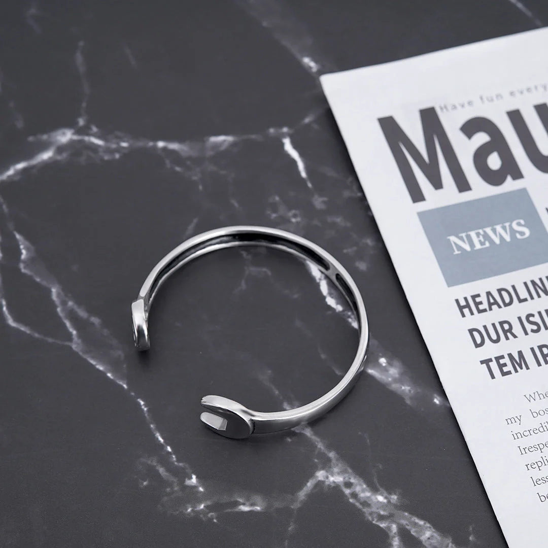 Sleek stainless steel personalized wrench bracelet with adjustable clasp, showcasing industrial-chic style