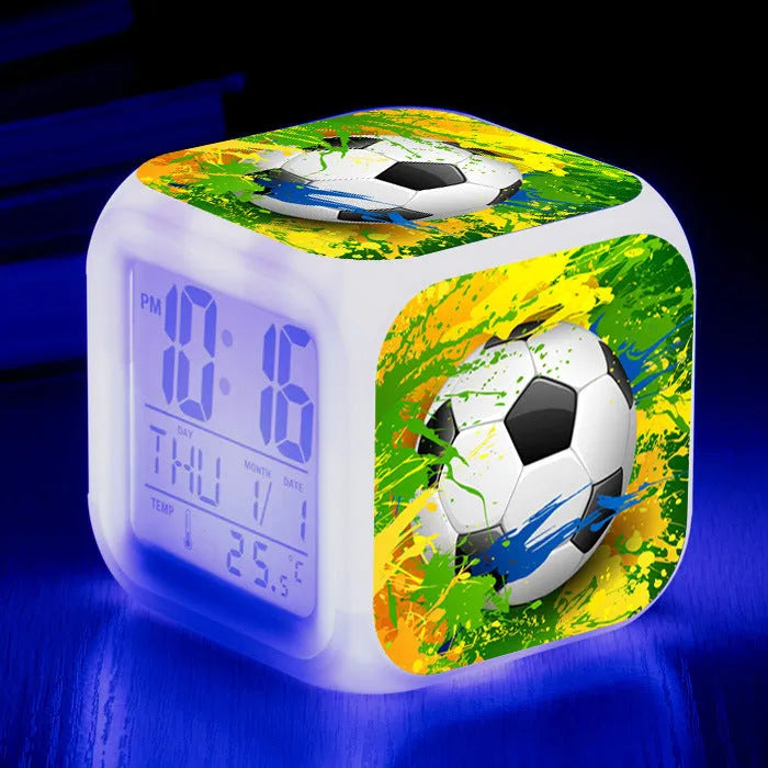 Colourful cartoon football pattern children's mute alarm clock on a table.