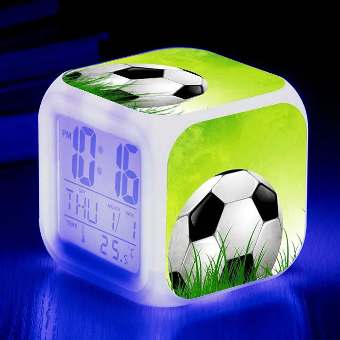 Colourful cartoon football pattern children's mute alarm clock on a table.