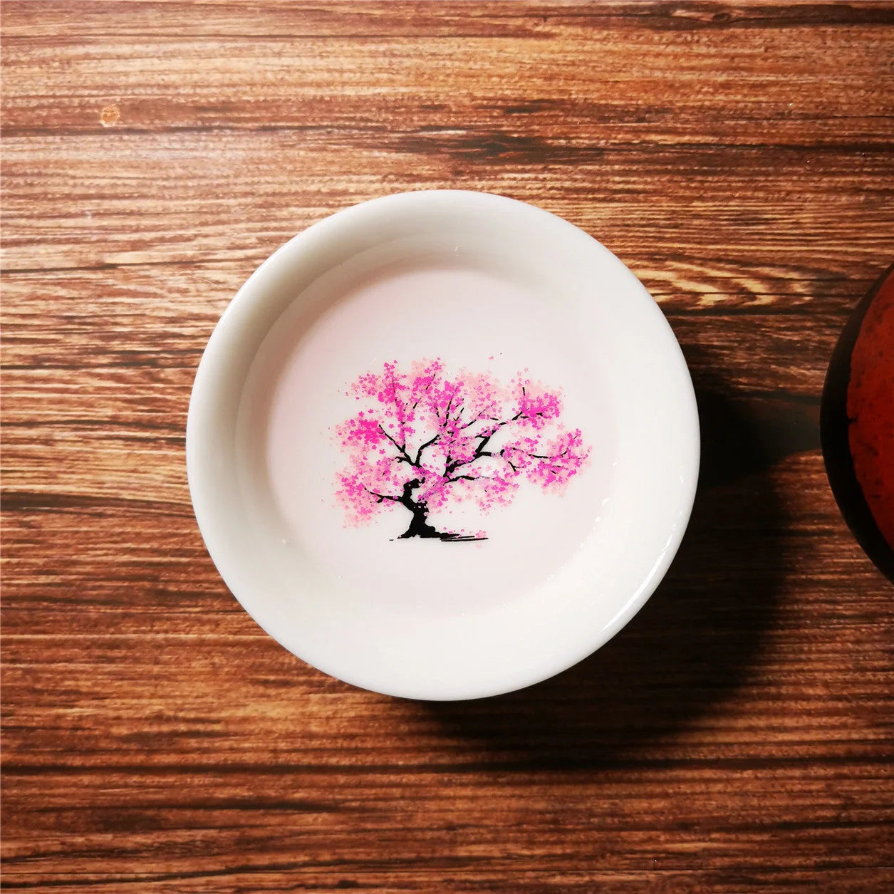 Magic Sakura Cup - Japanese color-changing ceramic teacup with sakura design