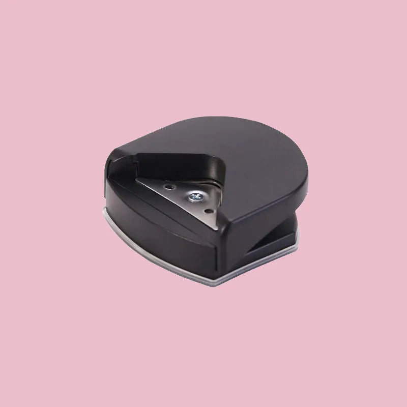 Black plastic and metal business card corner cutter on a white background