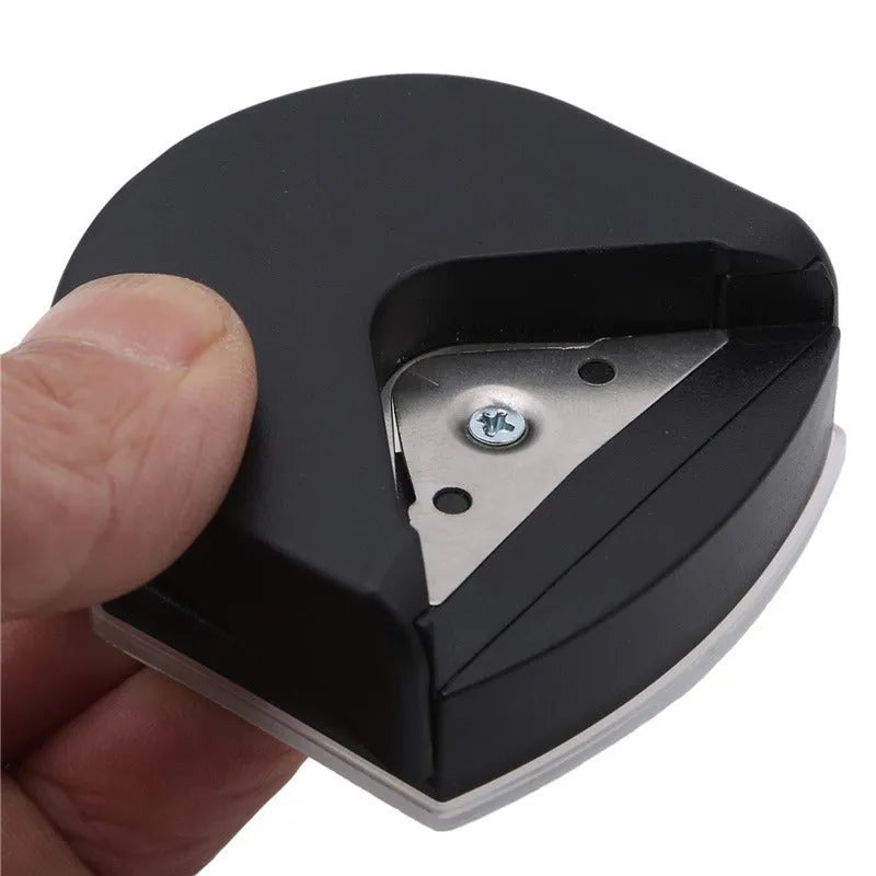 Black plastic and metal business card corner cutter on a white background