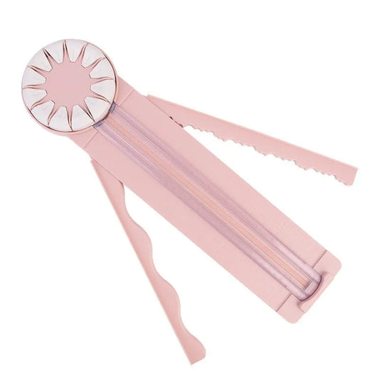 Pink 12-in-1 paper cutter with dotted guides measuring 46.2cm length on craft table