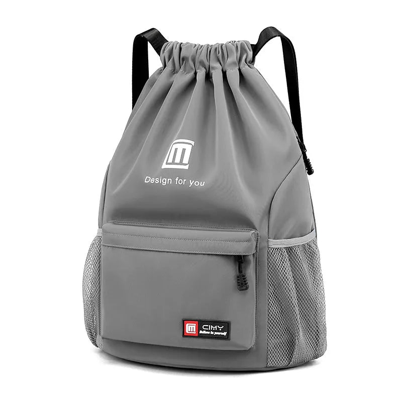 Large bucket-shaped travel backpack in blue with drawstring closure and soft black shoulder straps.
