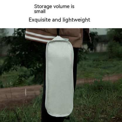 Outdoor folding chair with 600D Oxford cloth in ivory white, shown in folded position with storage bag