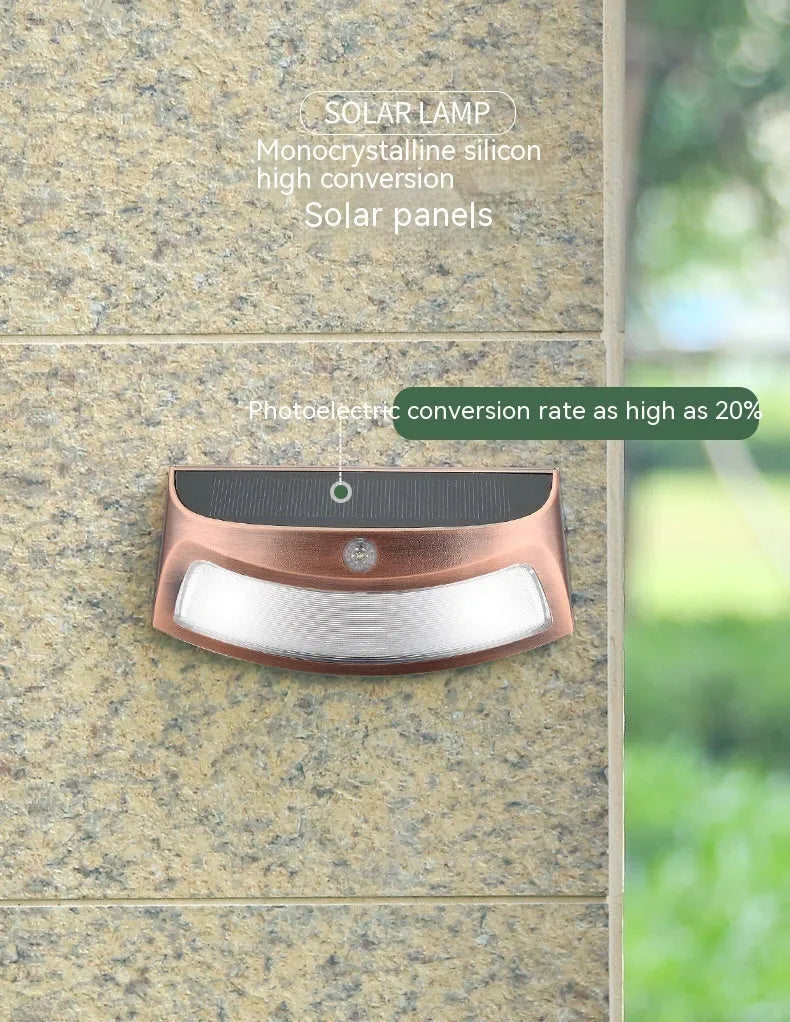 Solar outdoor wall lamp with smiling face design measuring 153mm × 76mm × 38mm for garden lighting